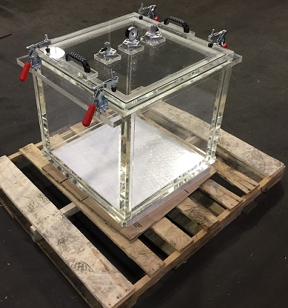 large rectangular clear acrylic vacuum chamber on pallet