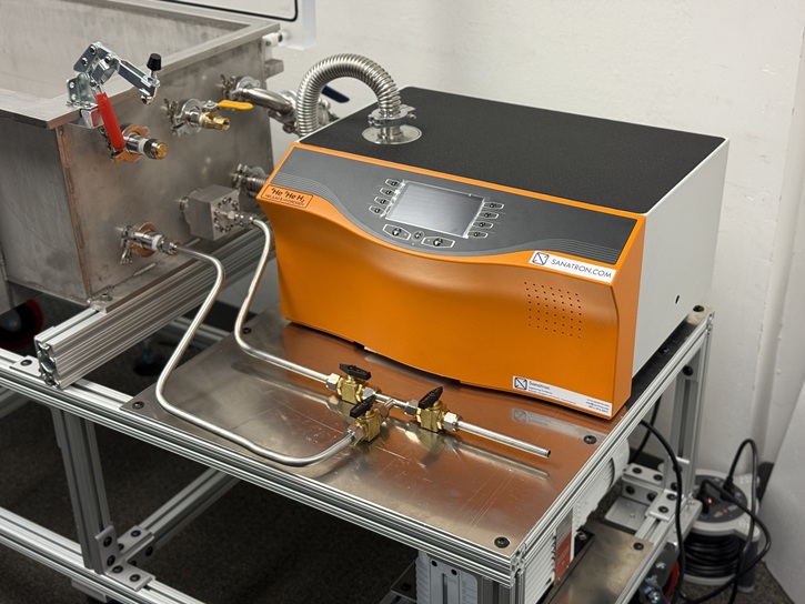 Helium leak testing setup with a mass spectrometer leak detector connected to a test fixture